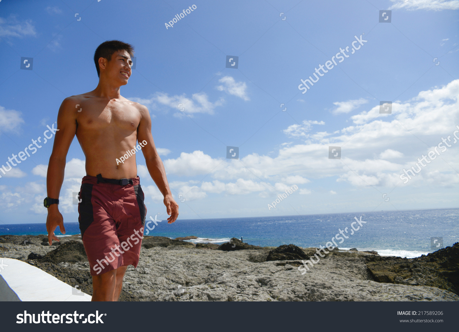 man walking by the sea at sunset outdoors