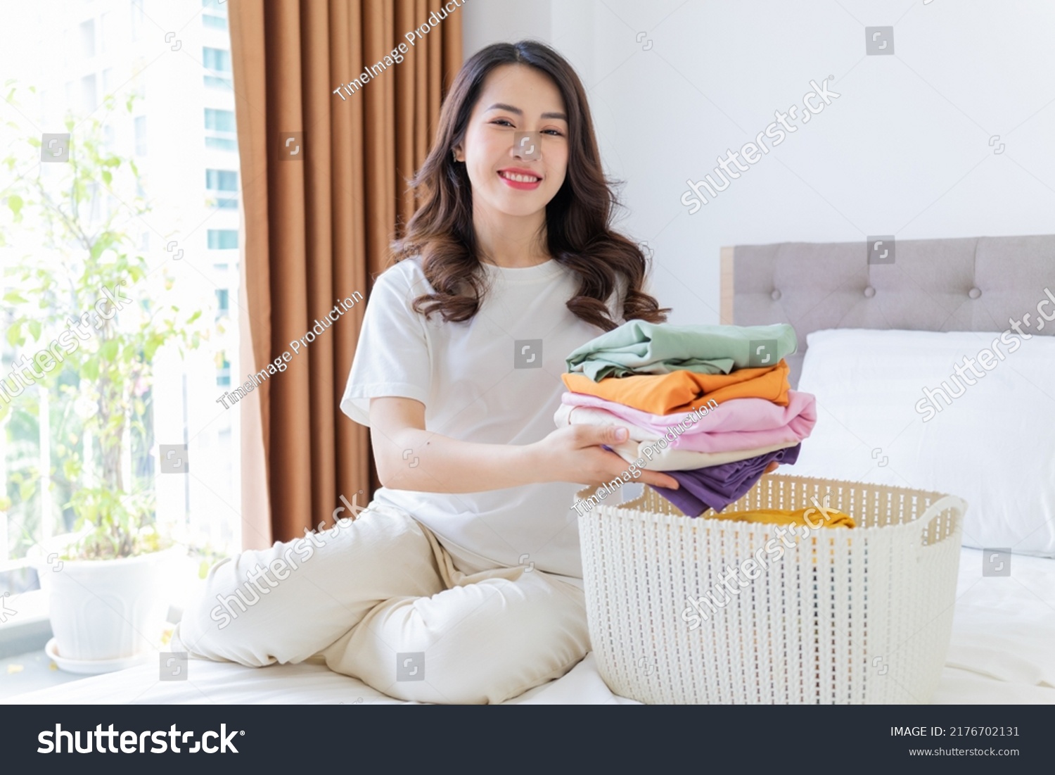 Young Asian woman folding clothes
