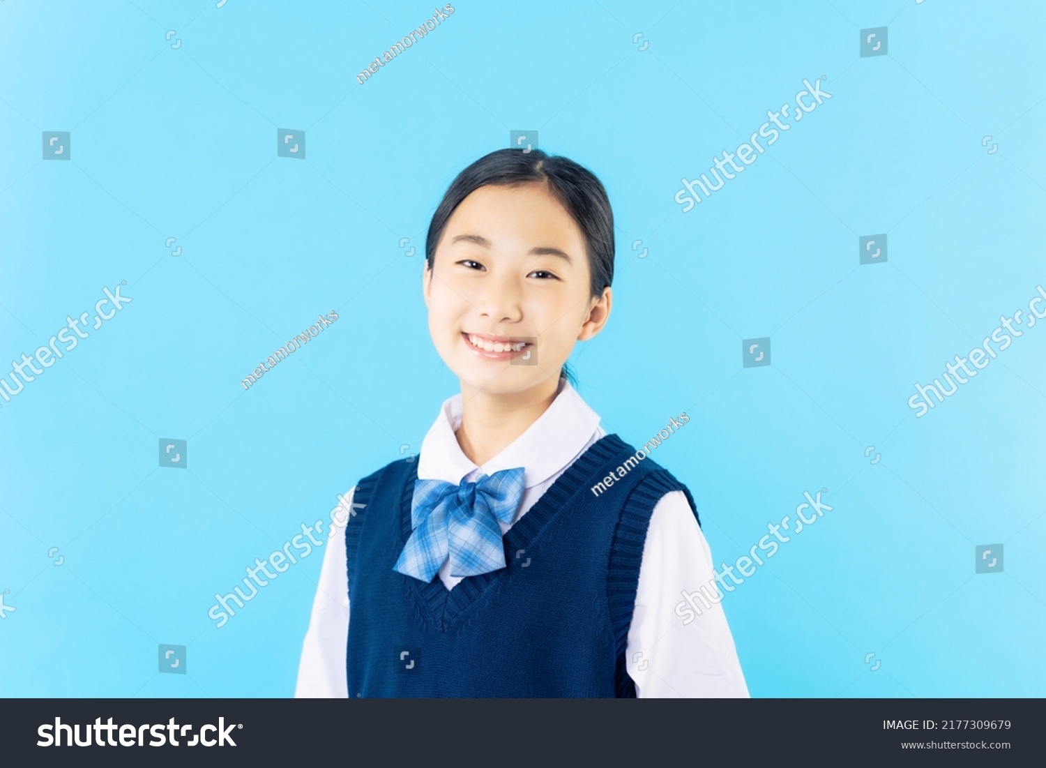 Smiling Asian schoolgirl with school uniform.