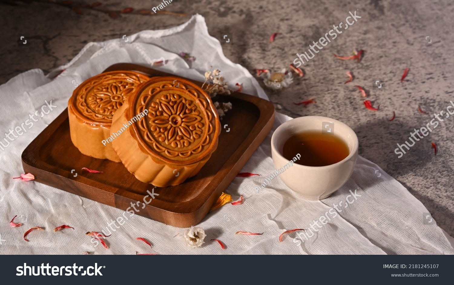 Mid autumn festival mooncake and cup of tea on stone table