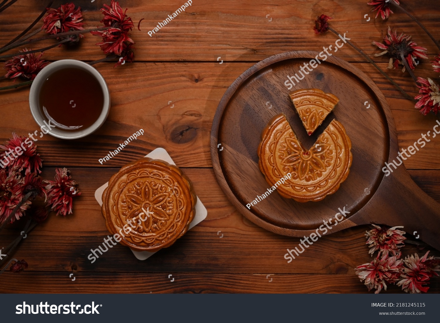 Top view  Traditional Chinese mooncakes  tea and dried flower on rustic wooden background