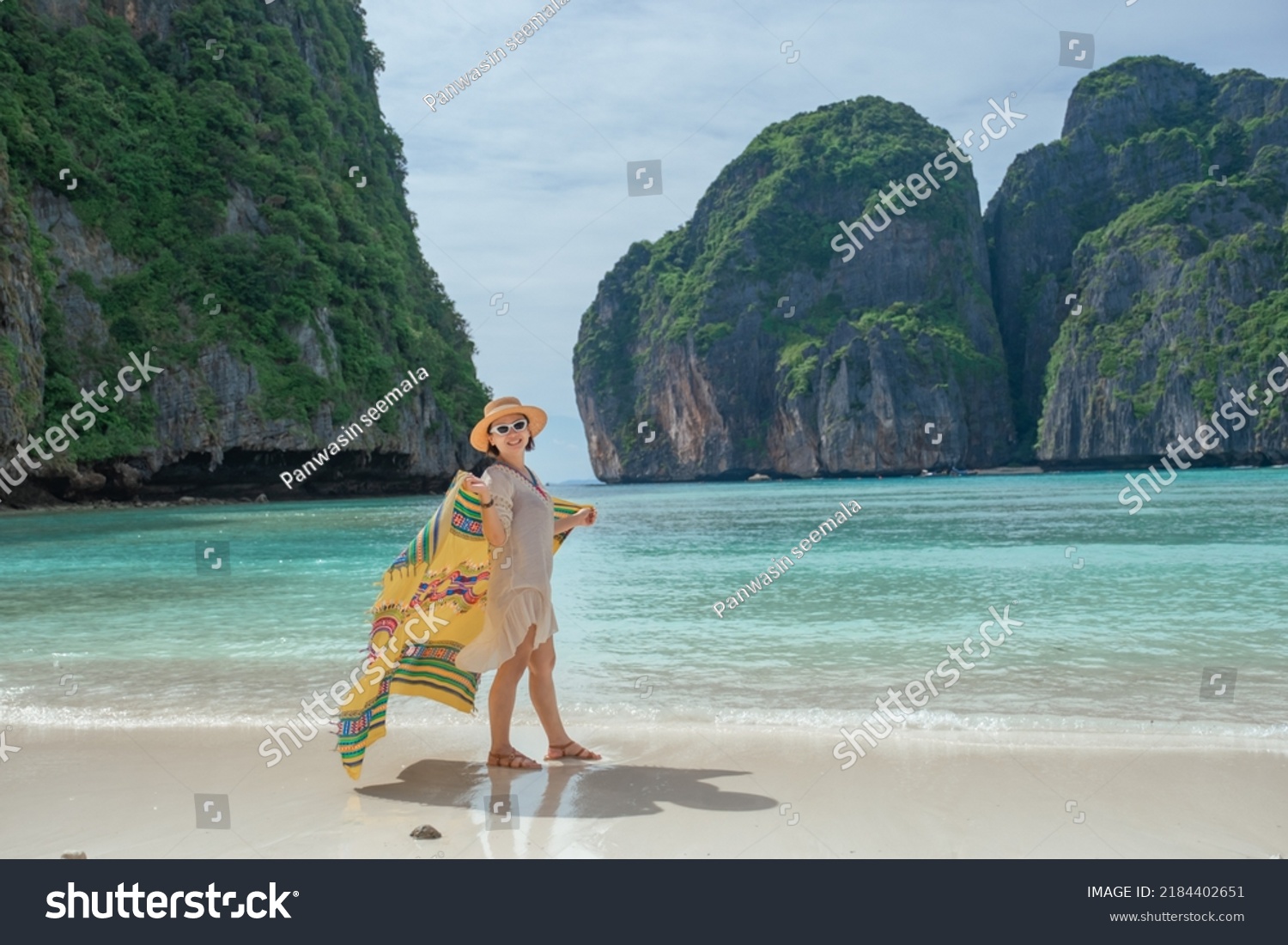 ํYoung asian women enjoy walking on the beach in Maya bay located in Phiphi island Krabi province.