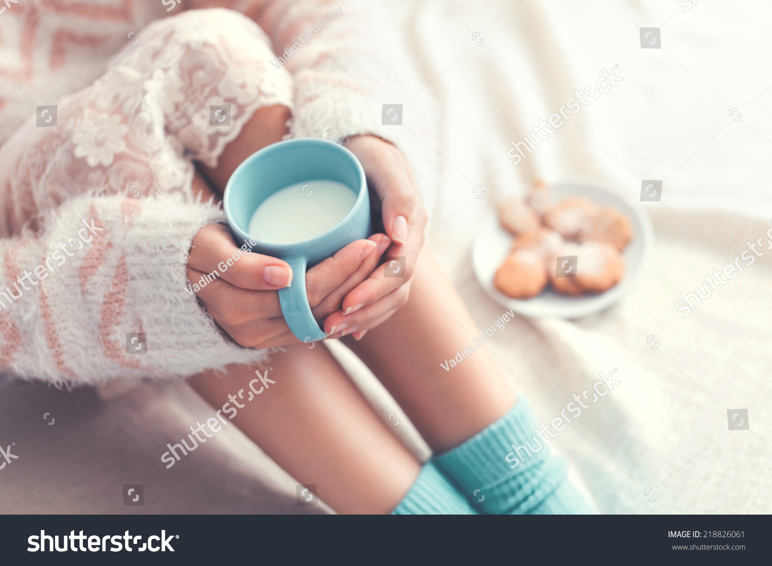 Soft photo of woman on the bed with cup of milk in hands  top view point
