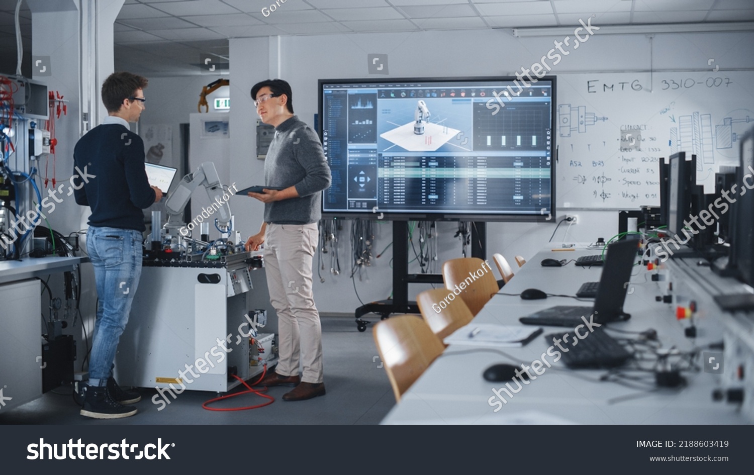 Team of Future Robotics Engineers Working on Robot Arm Design And