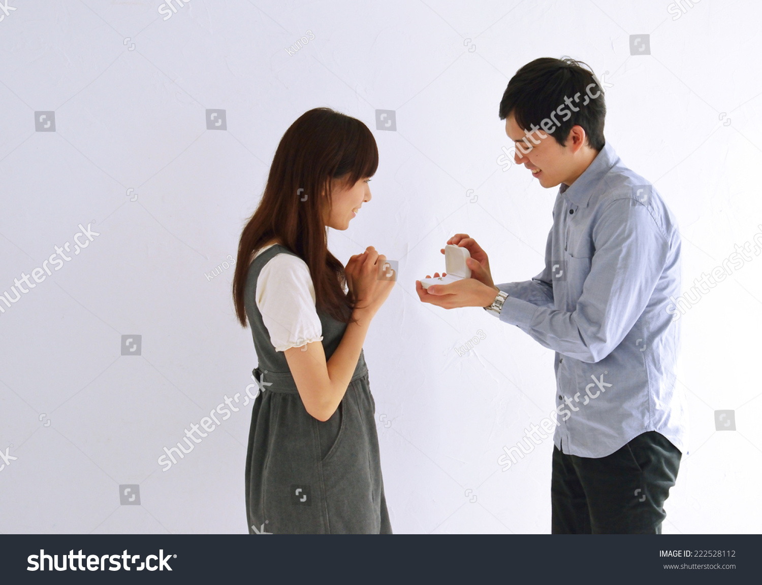 Man surprising his girlfriend with a proposal in house.