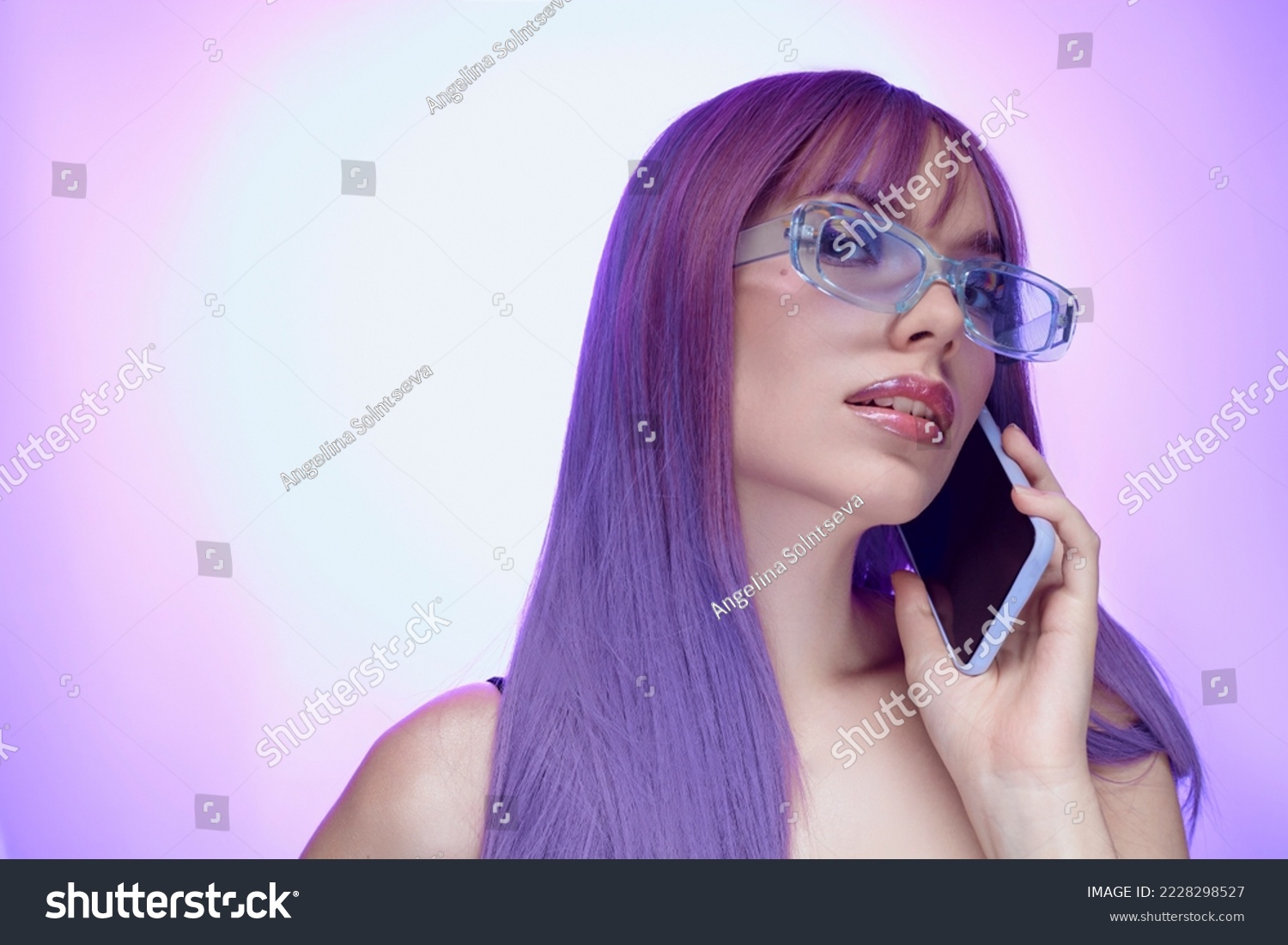 girl dressed in 2000s style and blue glasses  talking on a fashionable smartphone	