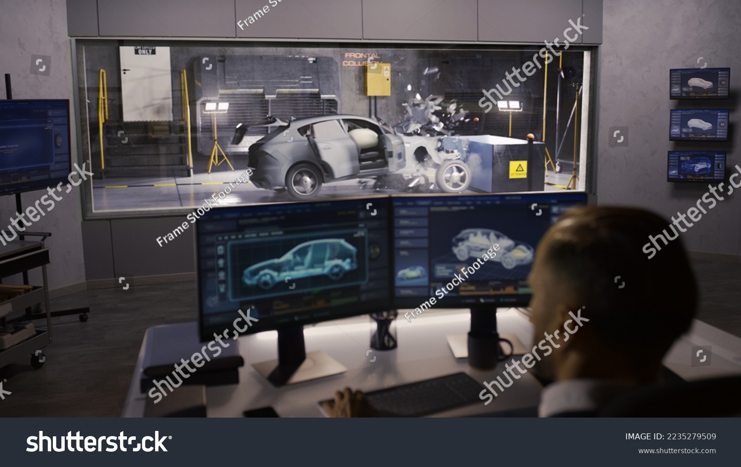 An engineer in a crash test lab uses a car crash test system to ...