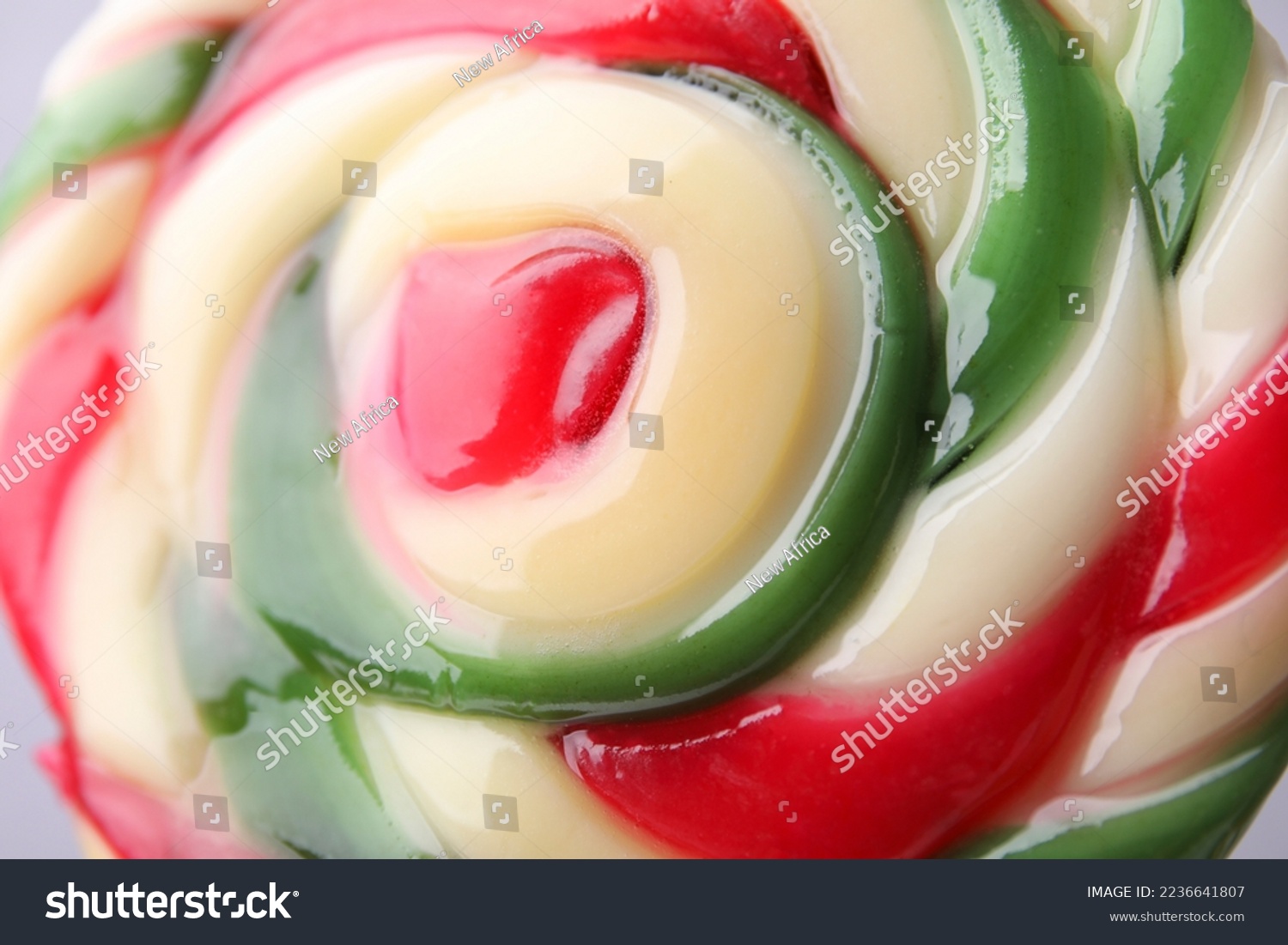Colorful lollipop swirl on grey background  closeup