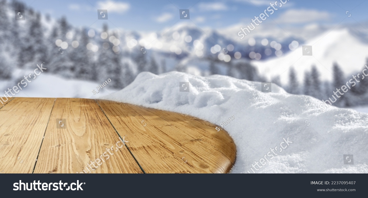 Retro wooden desk cover of snow and forst with landscape of mountains. Winter time. 
