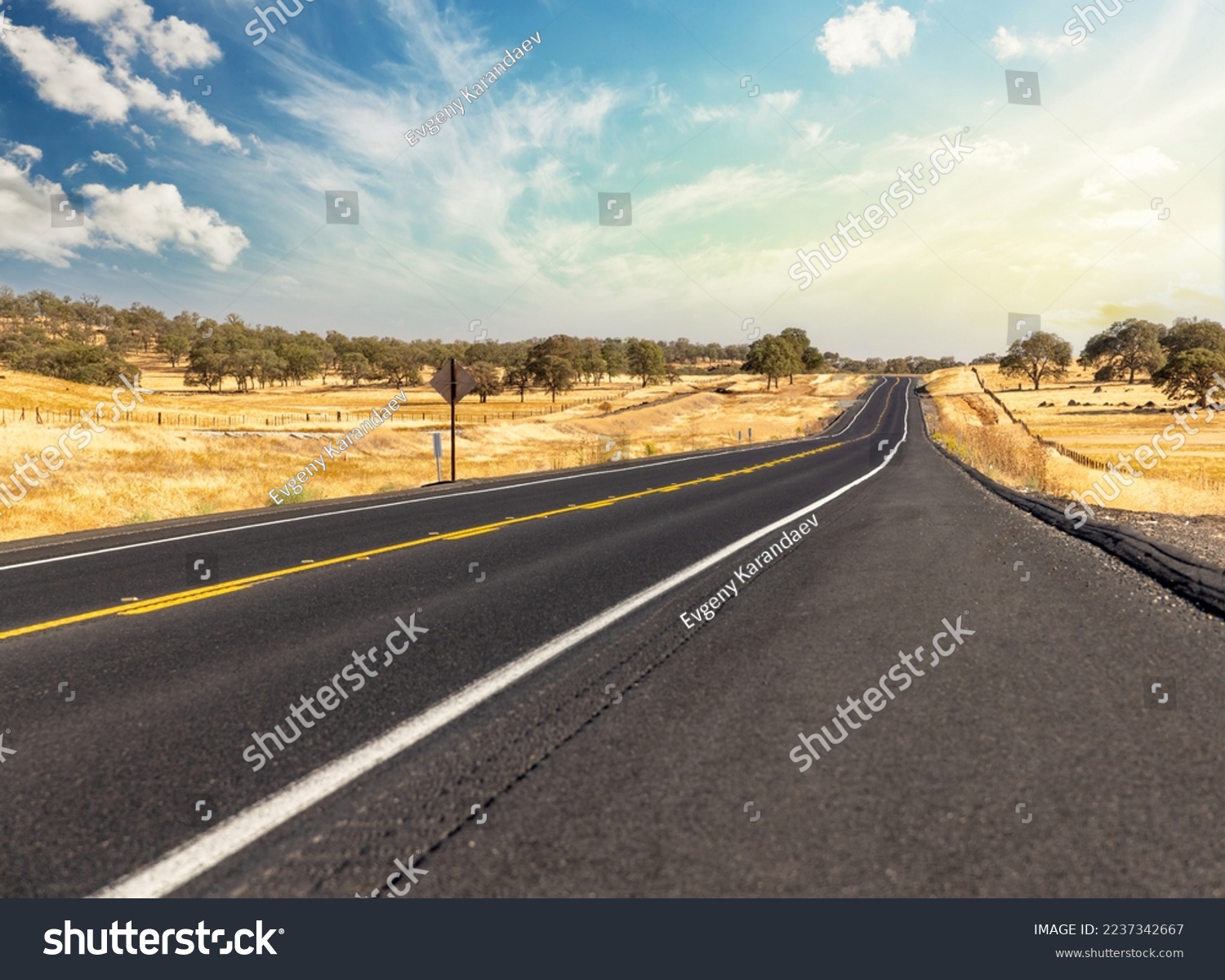 Asphalt road and country landscape with sunny sky. California State Route One