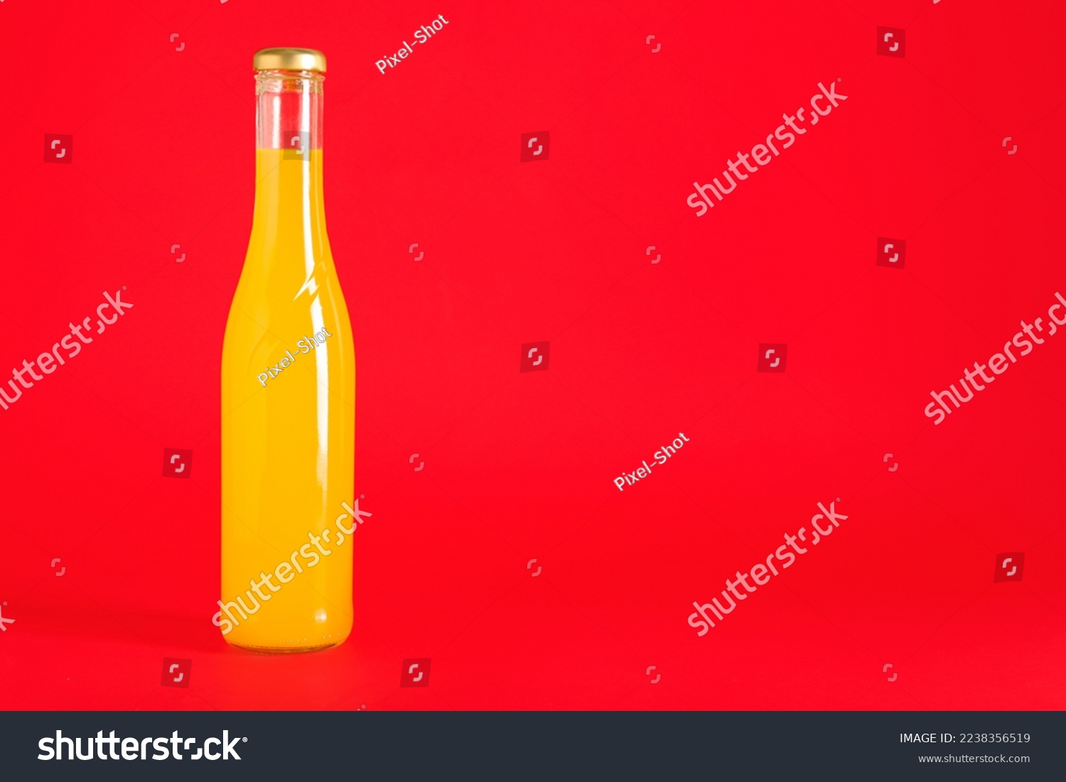 Bottle of drink on red background