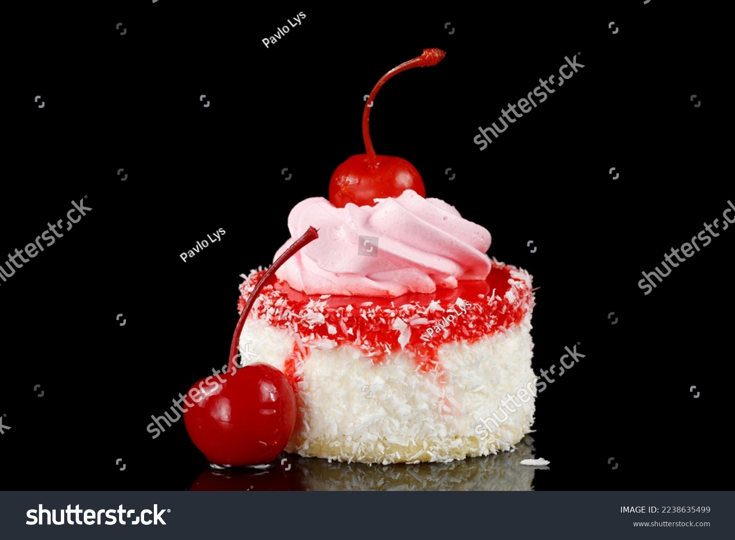 Cake with cherries. Homemade cupcake iced with a cherry on top