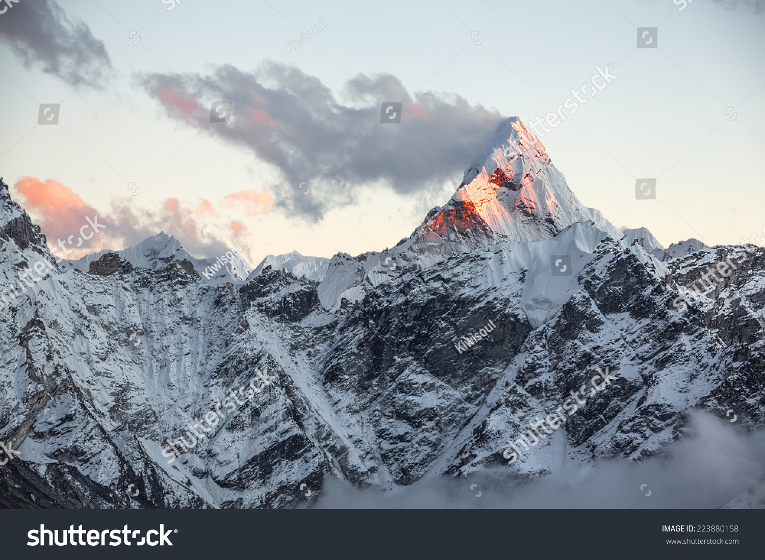 First rays of the rising sun on the top of sacred Ama Dablam peak (6814 ...