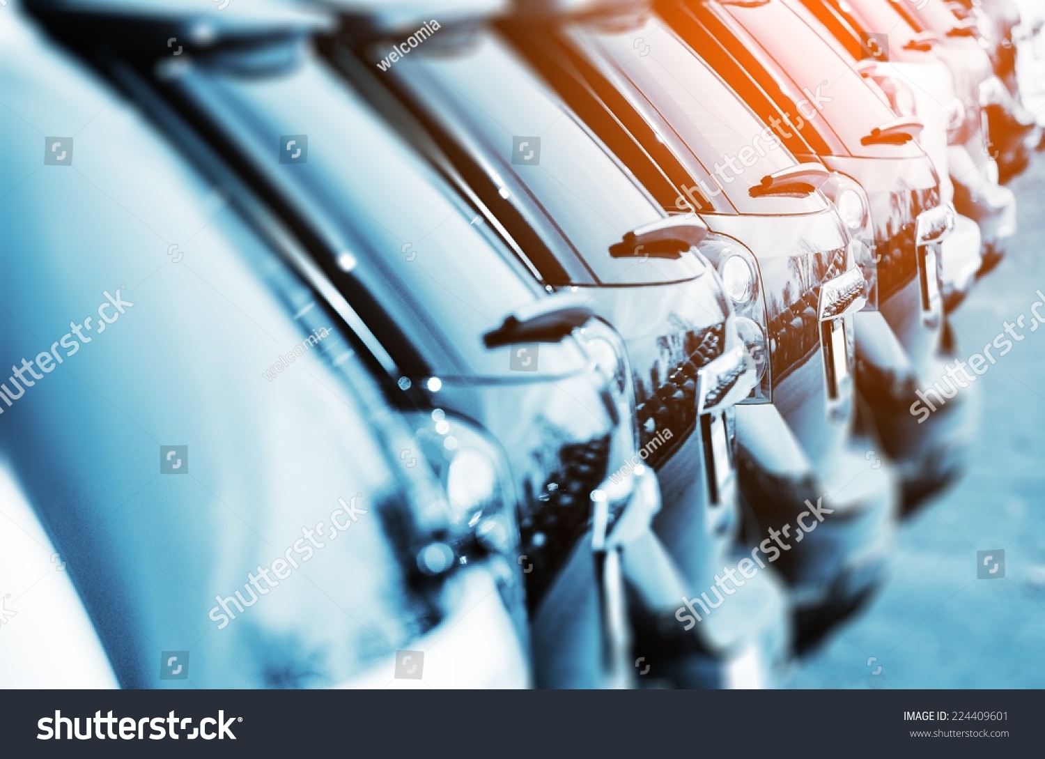 New Vehicles in Stock Closeup Photo with Color Grading. Brand New Cars For Sale in a Row. Cars Industry.