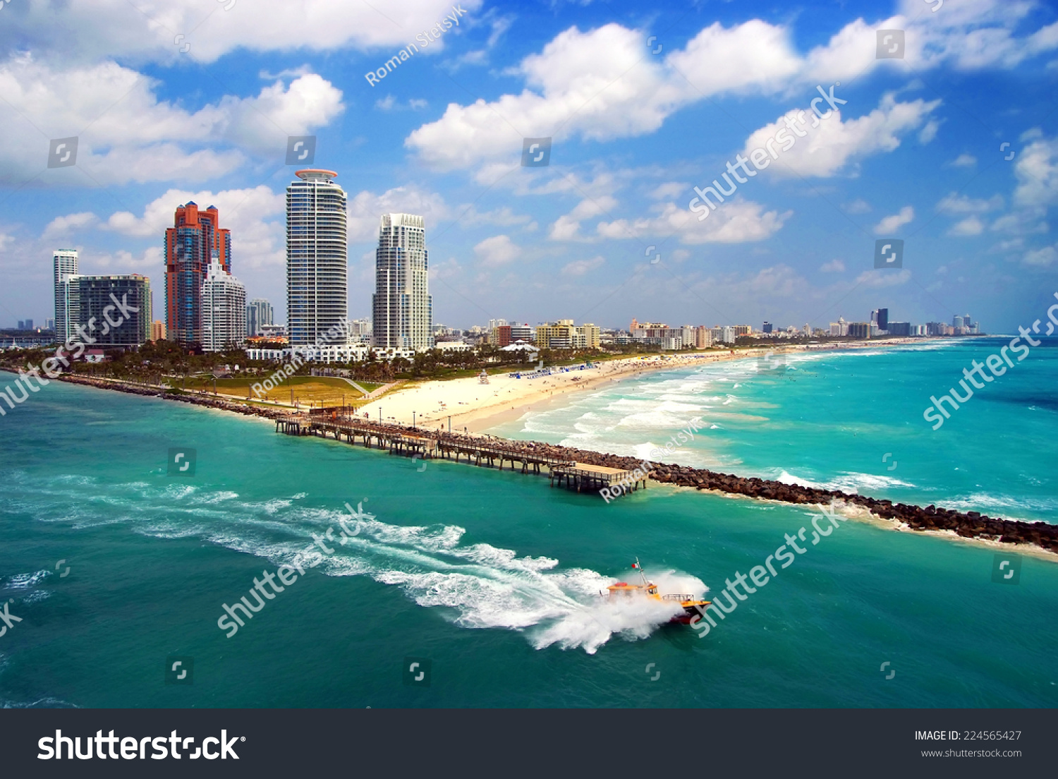Aerial view of South Miami Beach with Pilot boat sailing next to the city line