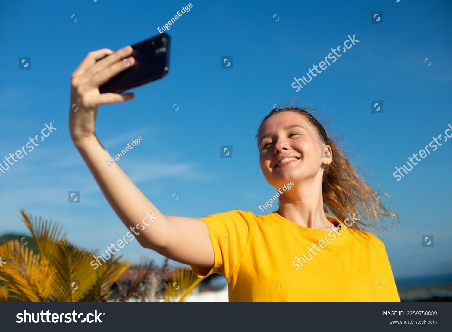 young beautiful happy woman blogger is taking selfie picture of herself ...