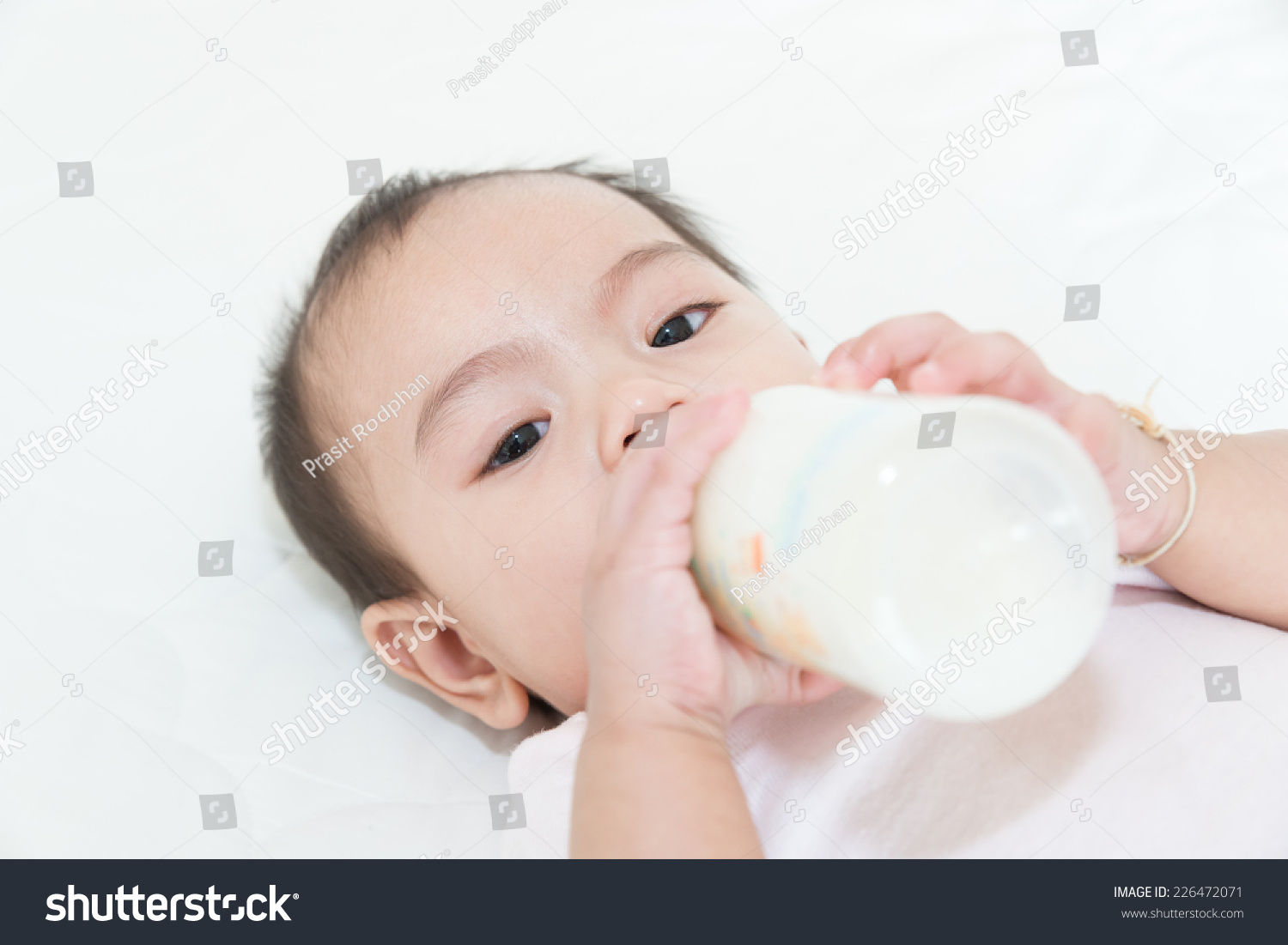 Asian baby infant eating milk from bottle