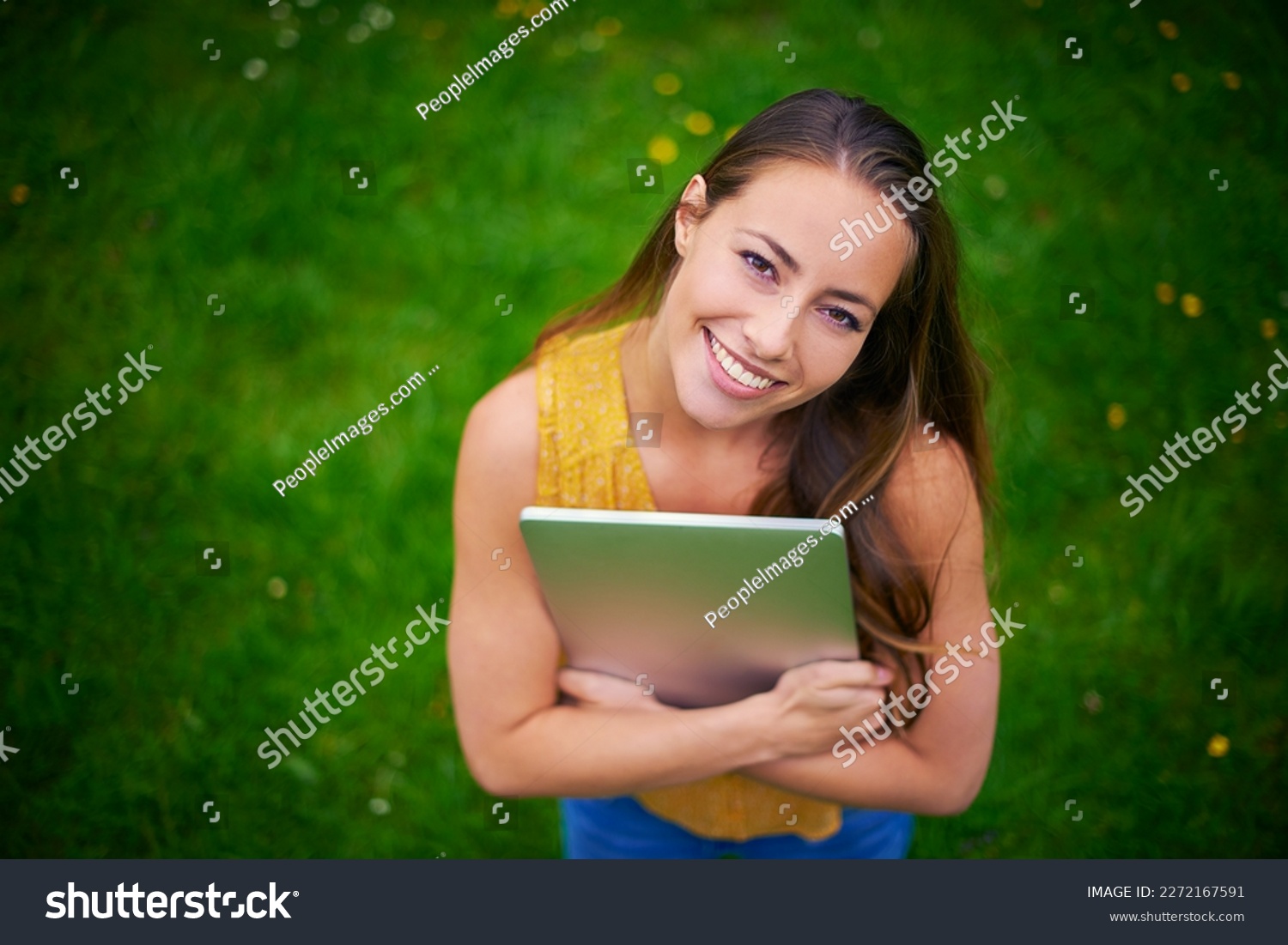 All I need is my laptop and awesome wifi speed. a happy young woman holding a laptop in the park.