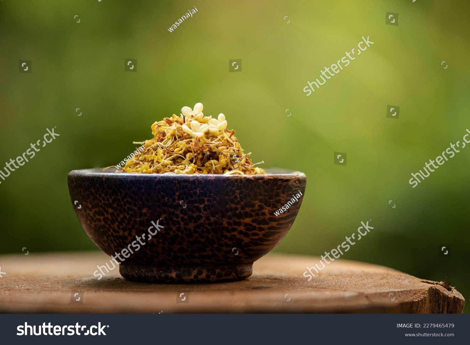 Fresh and dried sweet osmanthus flowers on nature background.