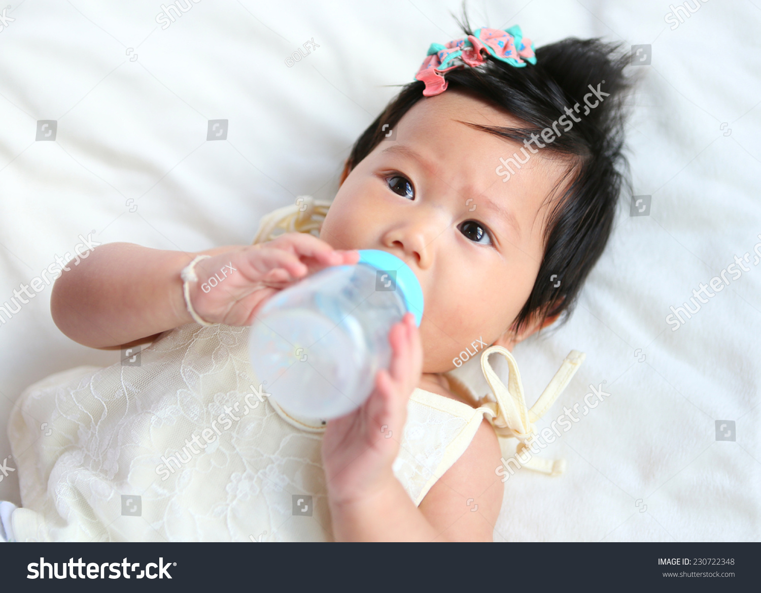 Asian baby infant eating milk from bottle