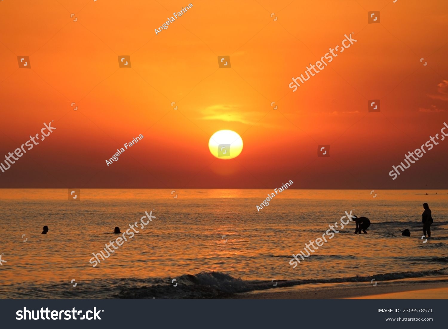 silhouette of group of people friends and family enjoying sunset on beach summer