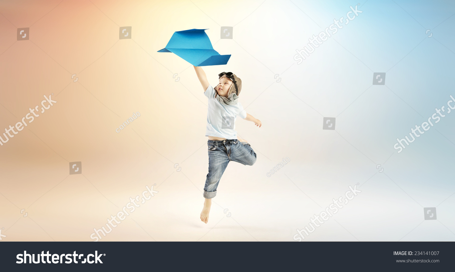 Happy kid playing with paper airplane
