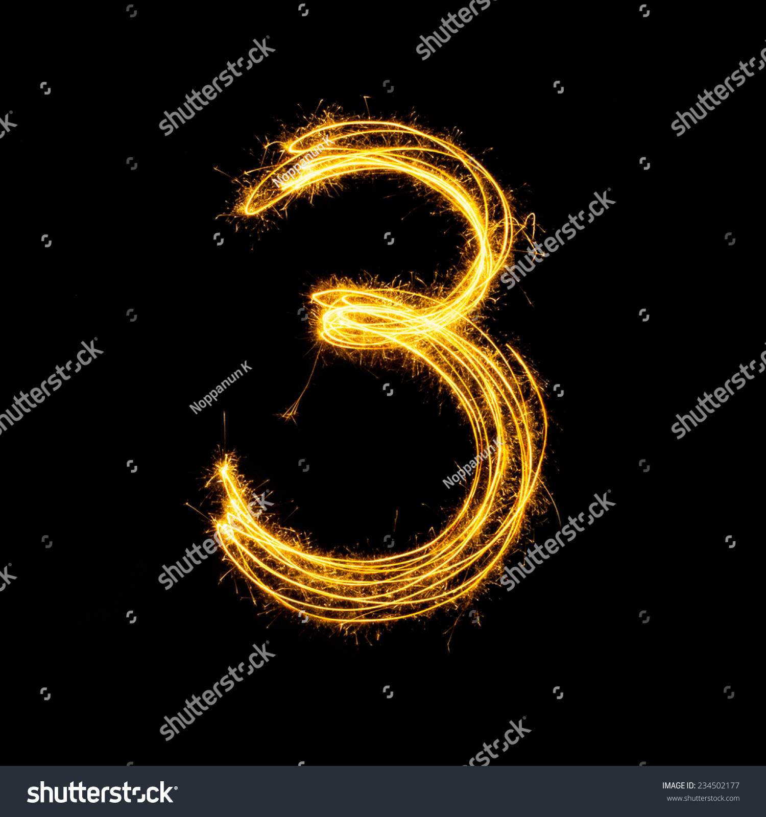 Sparkler firework light alphabet number 3 isolated on black background.