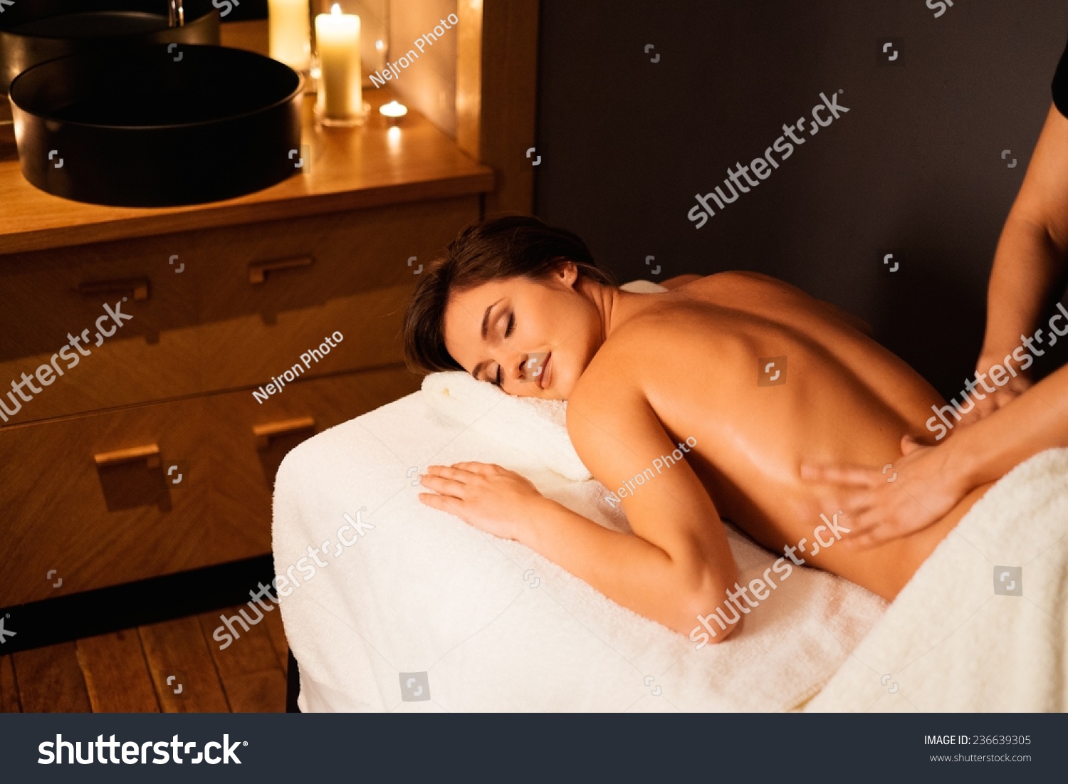 Beautiful young woman having massage in a spa salon