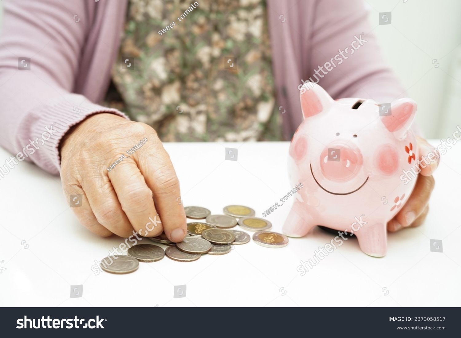 Retired elderly woman counting coins money with piggy bank and worry about monthly expenses and treatment fee payment.