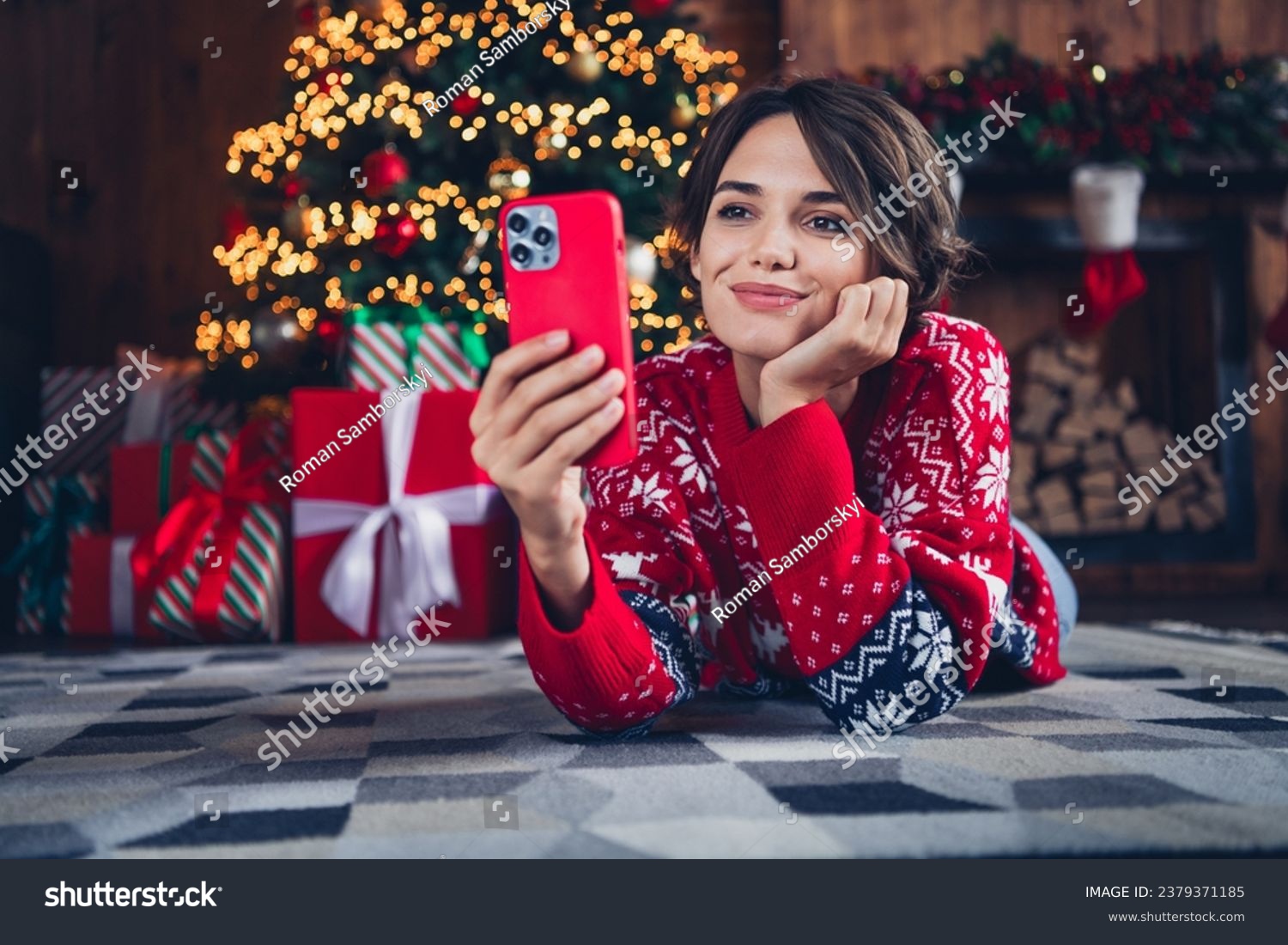 Full body photo of cute lady video call friends waiting santa claus hold iphone send wishlist shopping isolated xmas tree background