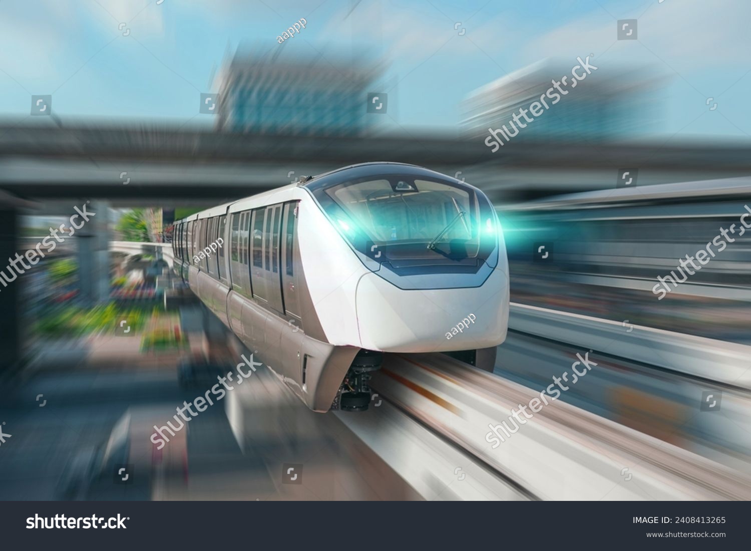 Modern high speed monorail train with bright headlights passes race station on the stage through a tunnel at a road junction.