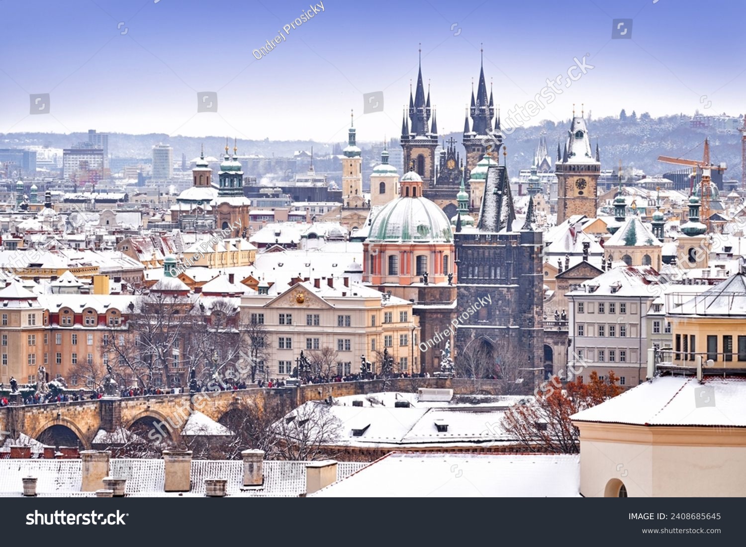 Snow in Prague  rare cold winter conditions. Prague Castle in Czech Republic  snowy weather with trees. City landscape from beautiful town. Winter travelling in white Europe.