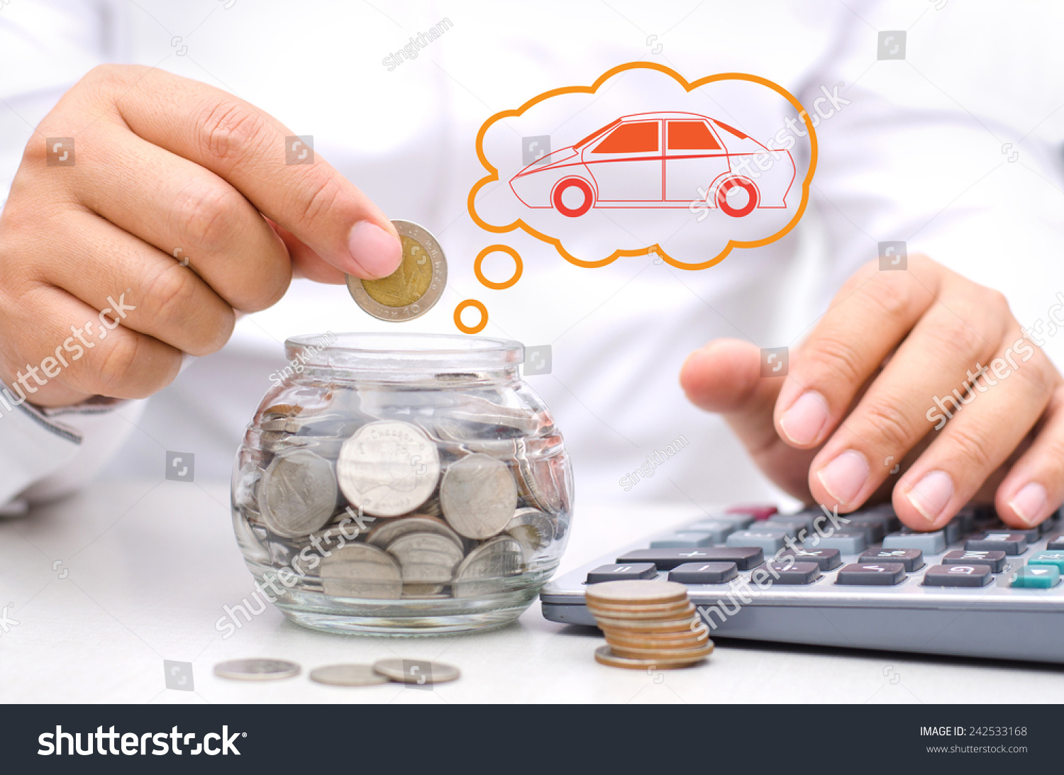 businessman hand putting money coins into glass piggy bank for buy car
