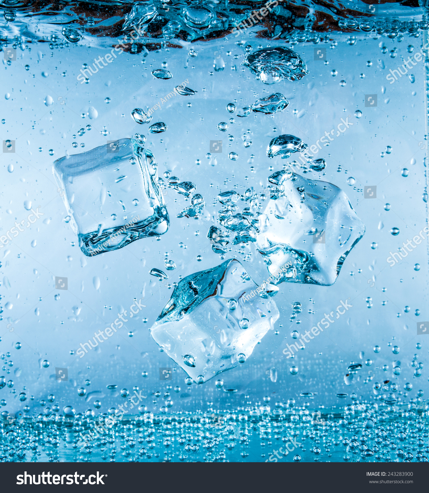 Ice cubes falling into the water sinking to the bottom. Abstract background.