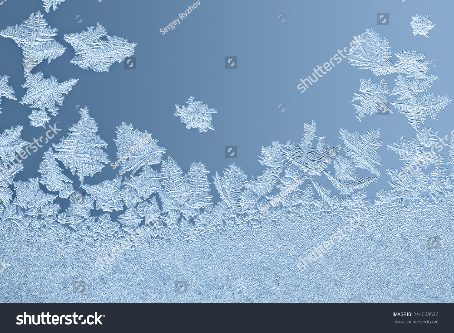 Beautiful frost patterns on glass in winter