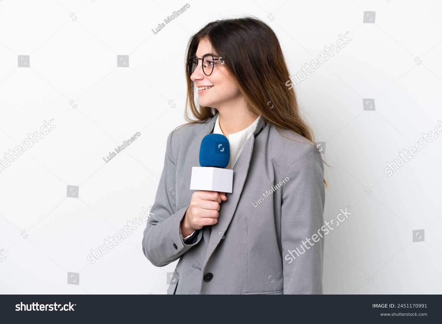Young caucasian TV presenter woman isolated on white background looking side