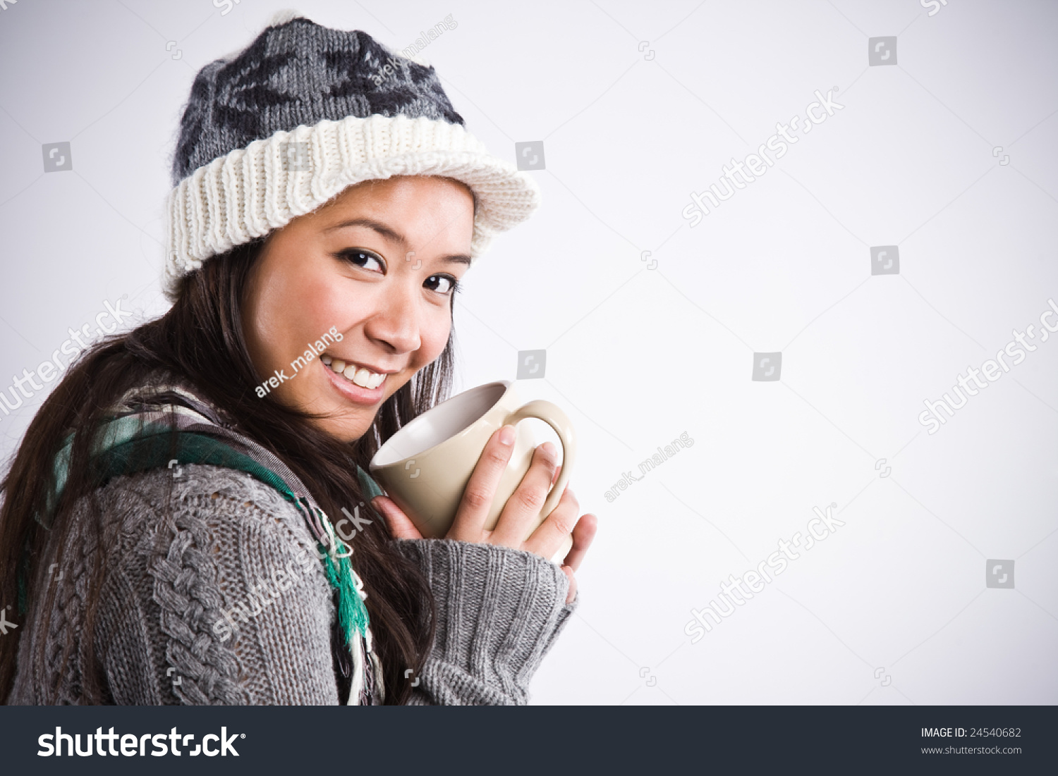 A shot of a happy beautiful asian woman drinking coffee