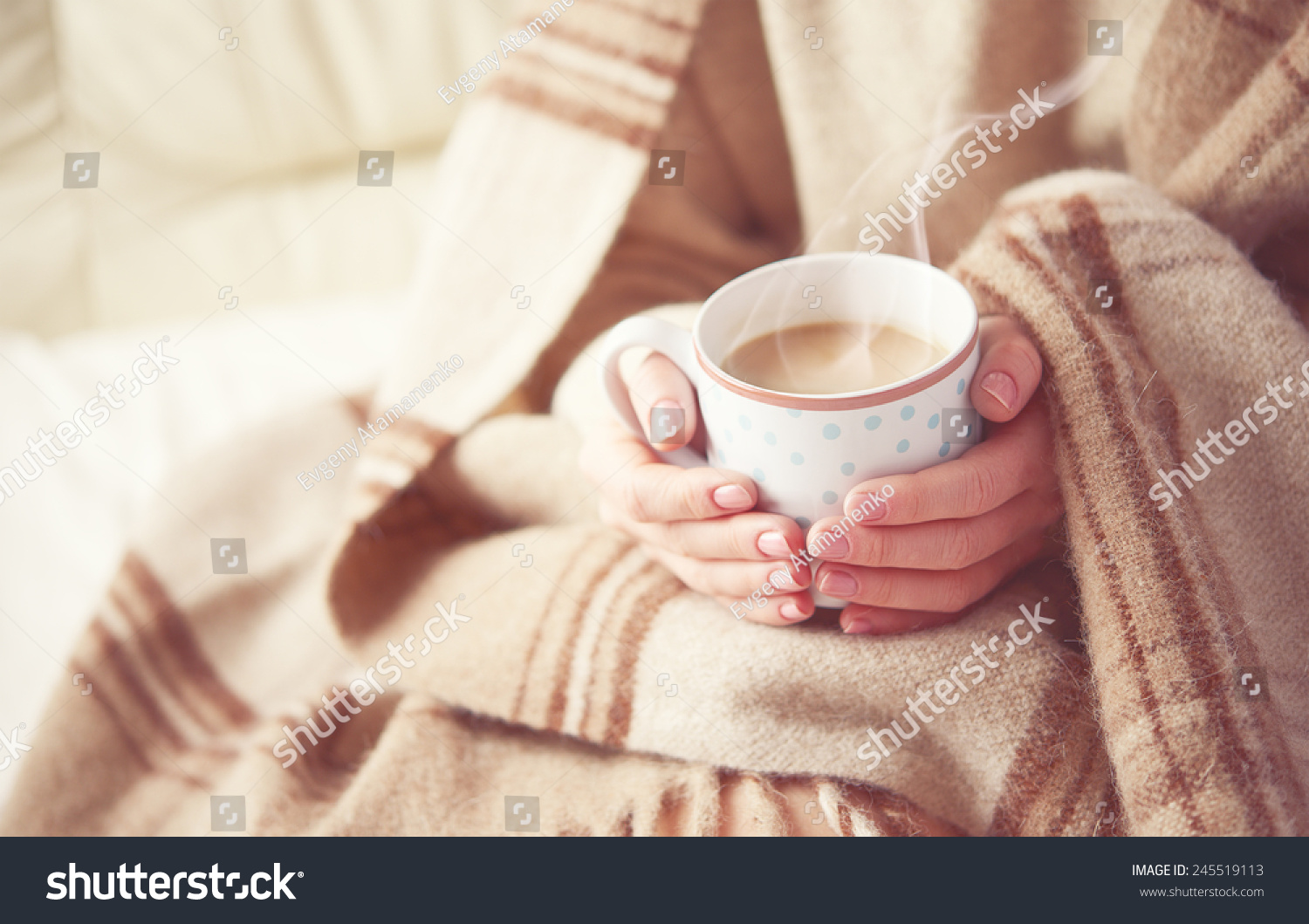 warm cup of hot coffee warming in the hands of a girl