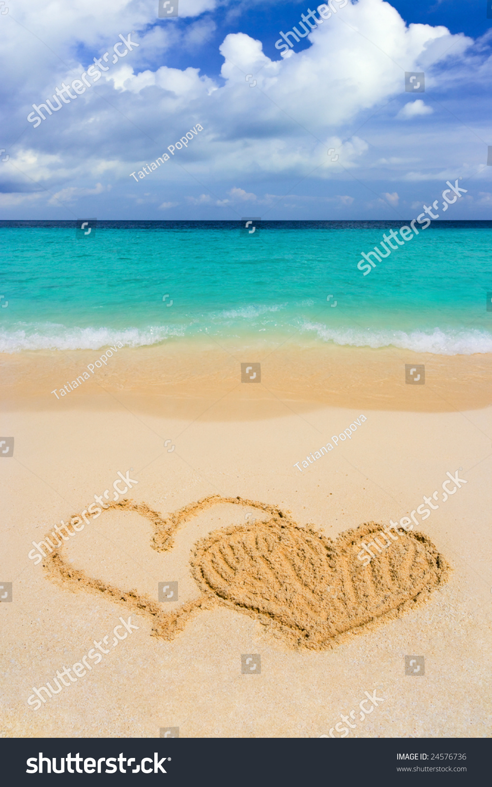 Drawing connected hearts on beach  love concept