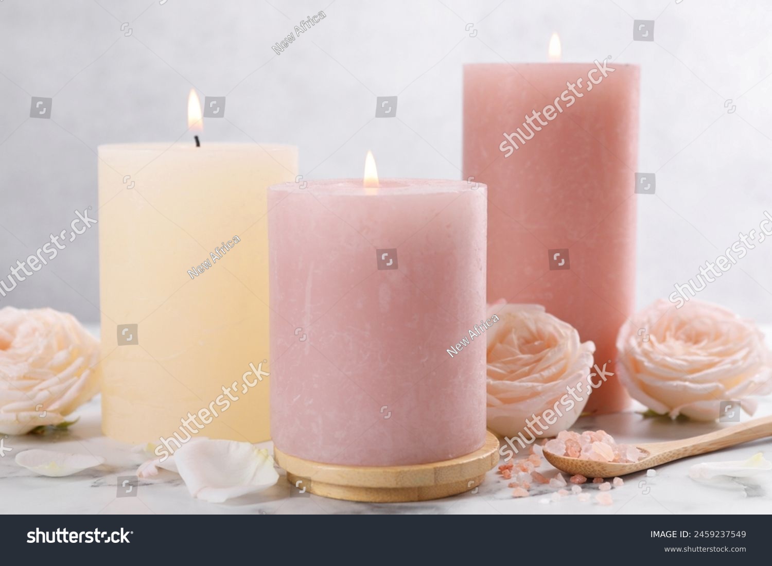 Spa composition with burning candles  flowers and sea salt on white marble table