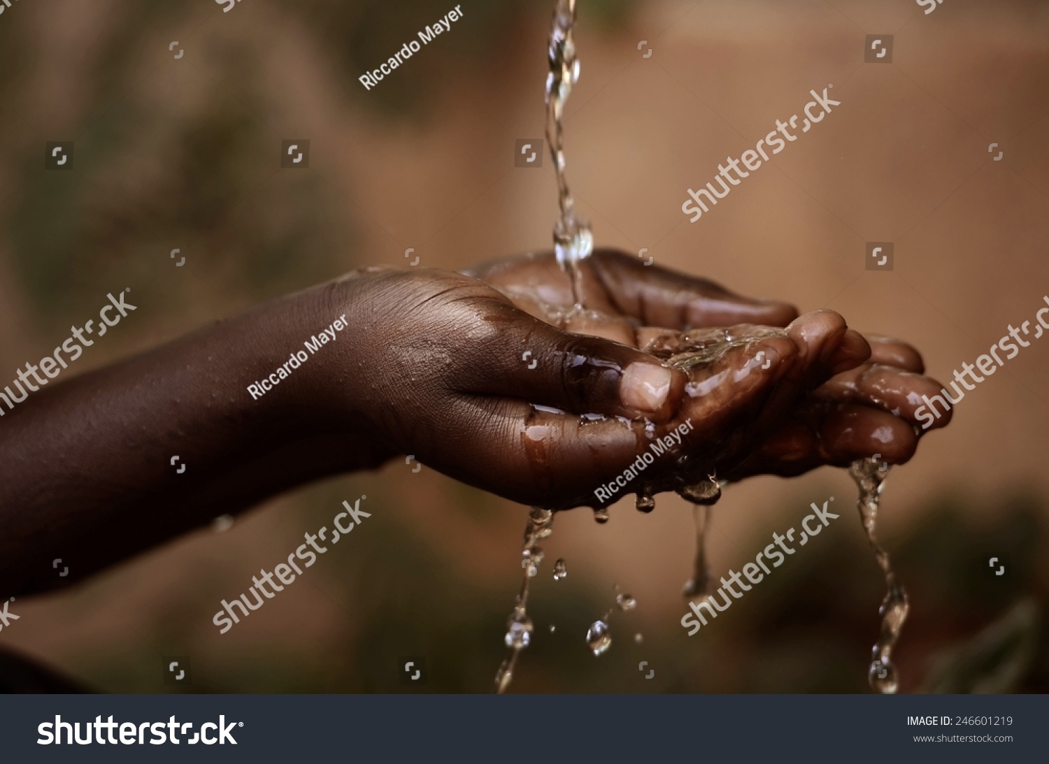 Social Issues: Water Pouring in African Child's Hands