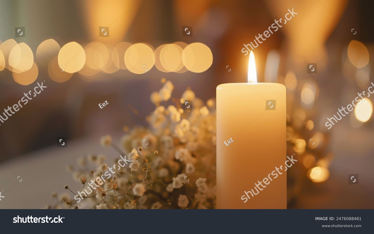 Beautiful candle scene with warm bokeh and white flowers for peaceful ambiance. An elegant candle scene with delicate white flowers and a soft  calming background.