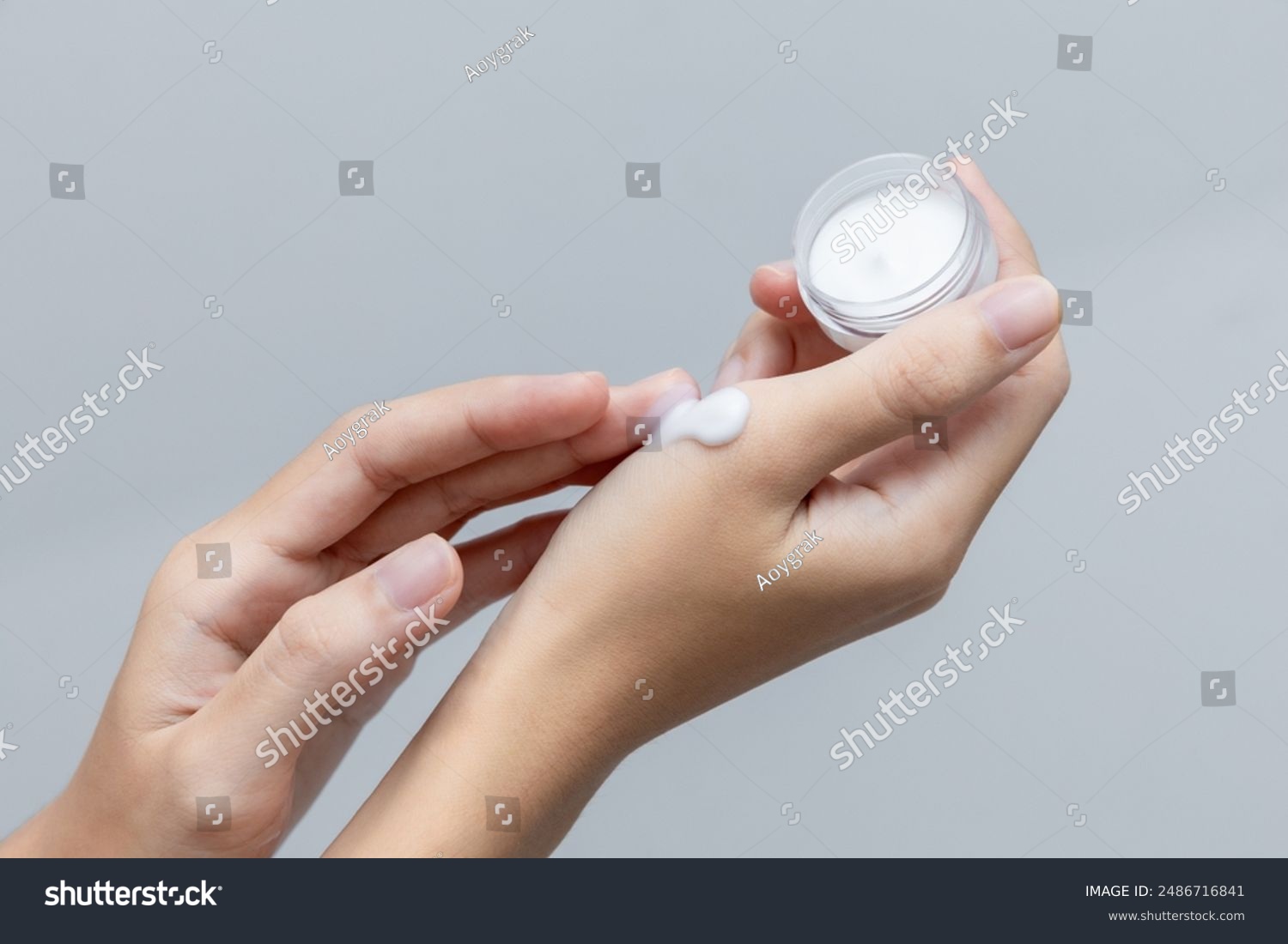a woman applies a cosmetic cream on her hands. hand skin care concept.