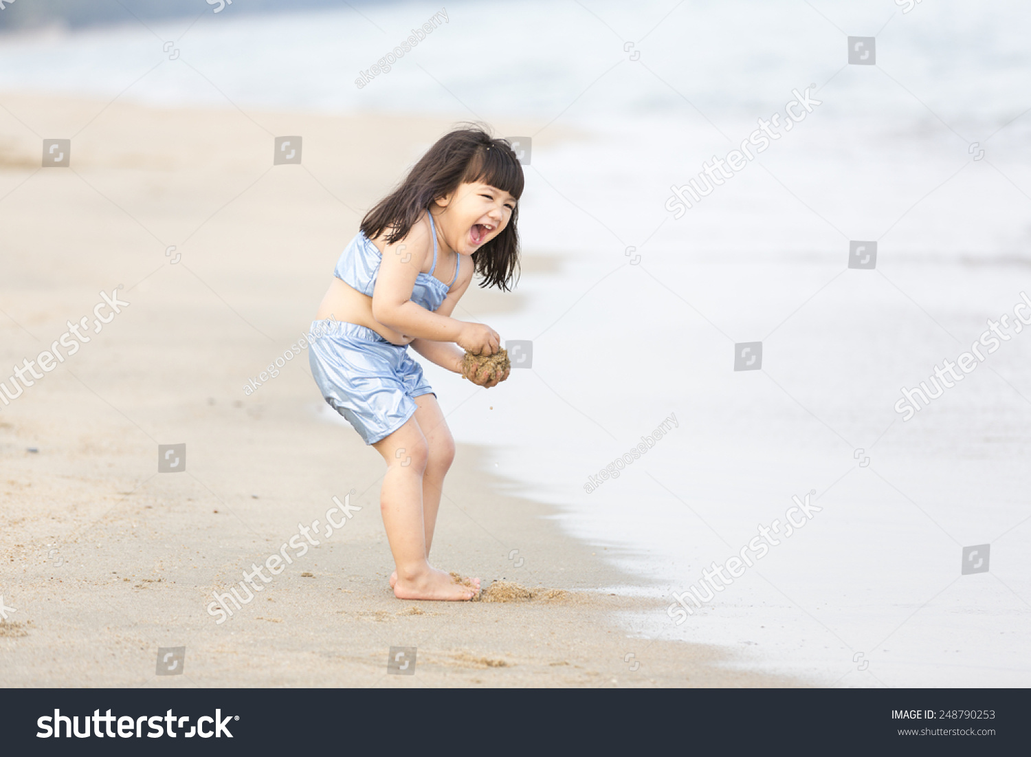 asian kid girl on the beach