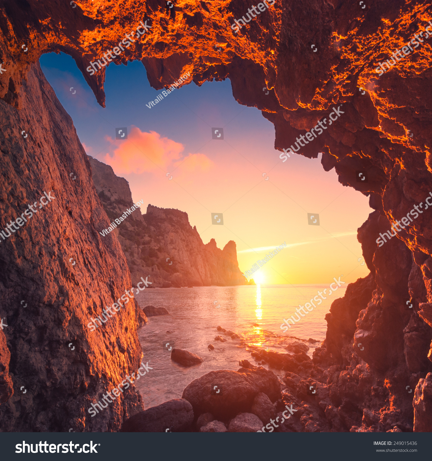 Beautiful sunrise from the mountain cave in a Crimea sea bay