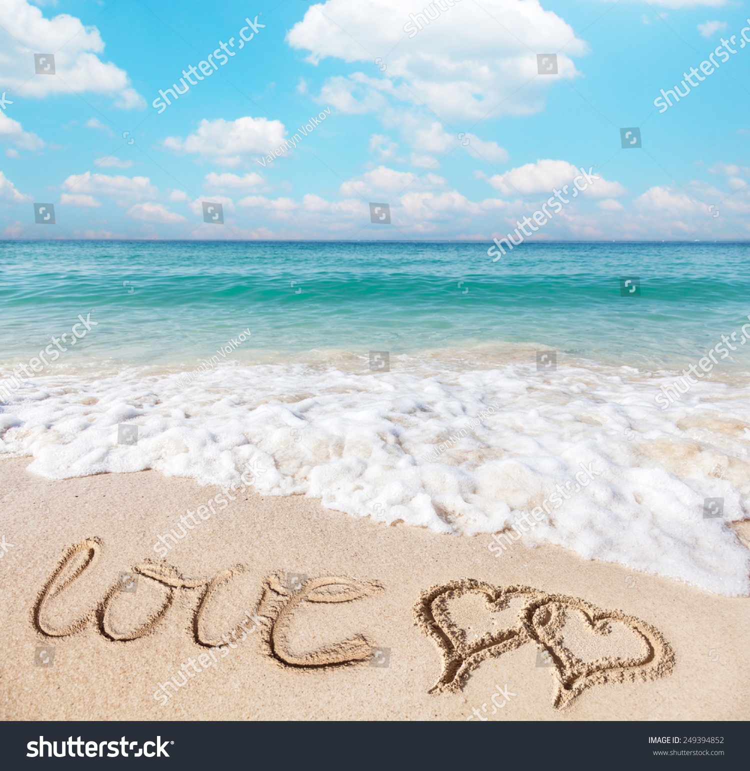 Hearts drawn on the beach sand.
