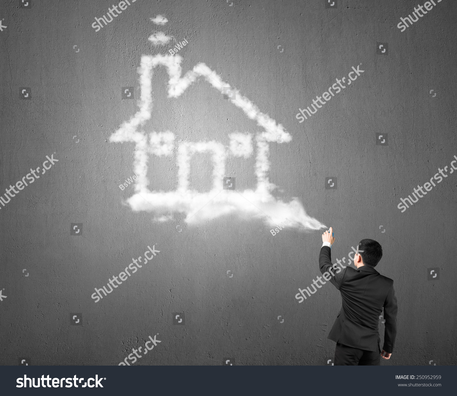 Businessman spraying house shape cloud paint with gray concrete wall background