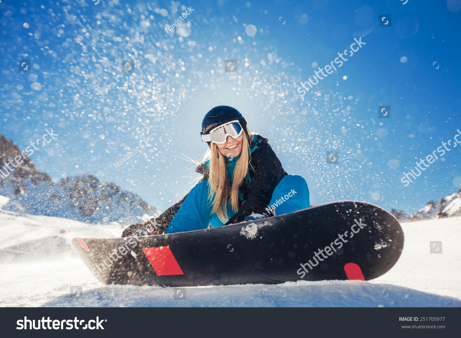 girl snowboarding in the mountains on the snowboard