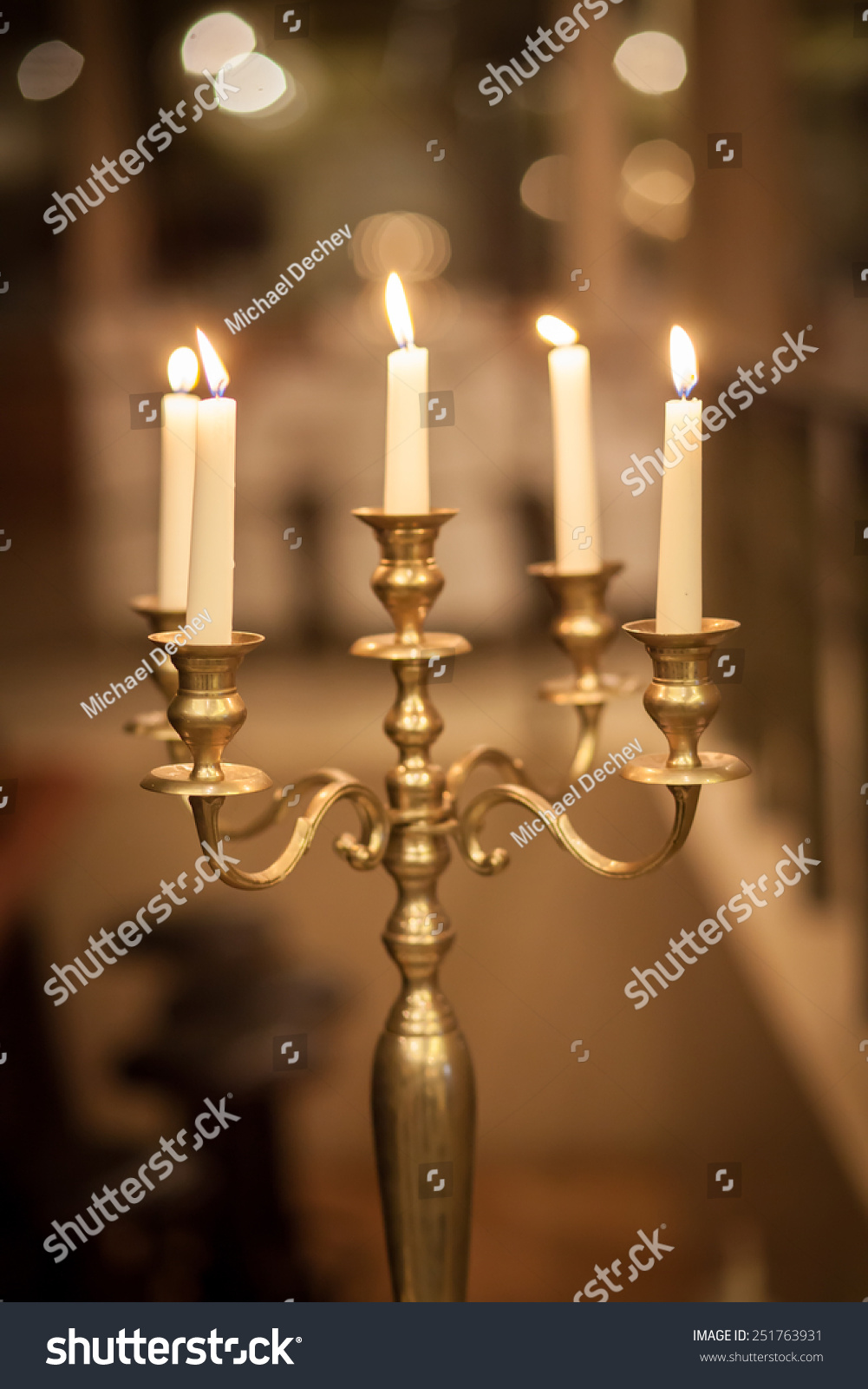 Vintage bronze candlestick with burning candles 