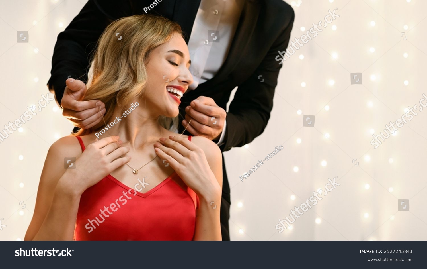 Anniversary Gift. Affectionate Man Presenting Golden Necklace To His Pleased Girlfriend At Romantic Dinner In Restaurant  Copy Space